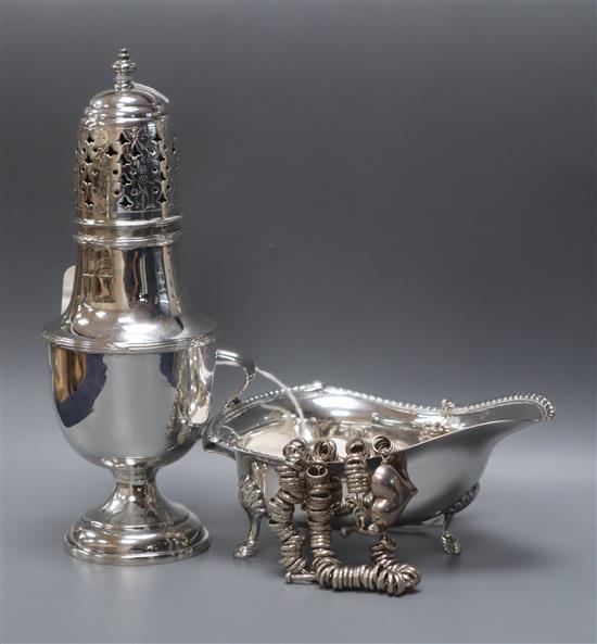 A George V silver baluster caster, London 1919, 4oz., a silver cream boat and a silver fancy link heart necklace and